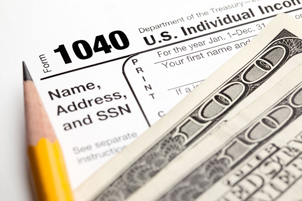 9153176 – tax time – closeup of u.s. 1040 tax return with pencil and money